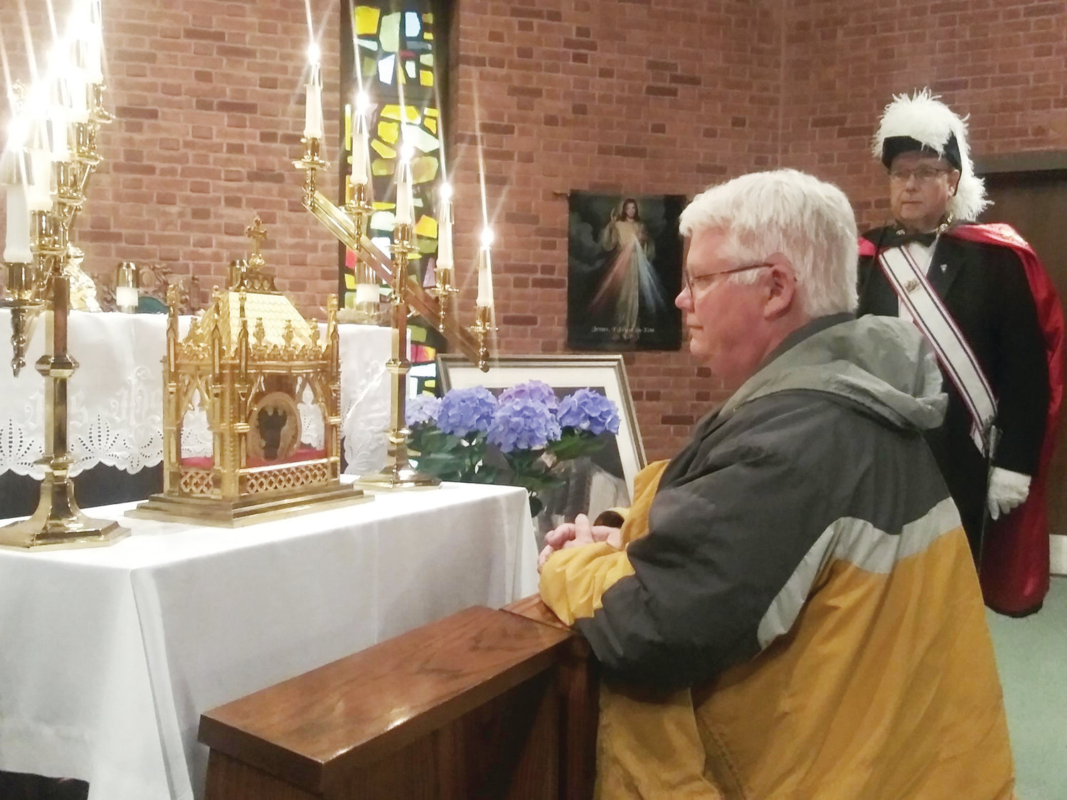 Michael Anthon of Portsmouth, who attends the Church of the Holy Ghost in Tiverton, venerates the incorrupt heart of St. John Vianney as Sir Knight of Columbus and District Deputy Bob Moniz stands watch.